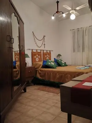 a bedroom with two beds and a mirror at Los Bubos in Villa Los Aromos