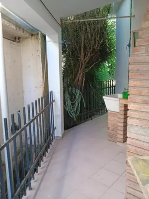 an entrance to a house with a gate and a tree at Los Bubos in Villa Los Aromos