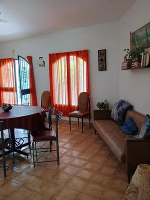 a living room with a couch and a table and chairs at Los Bubos in Villa Los Aromos