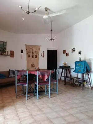a dining room with a table and chairs in a room at Los Bubos in Villa Los Aromos