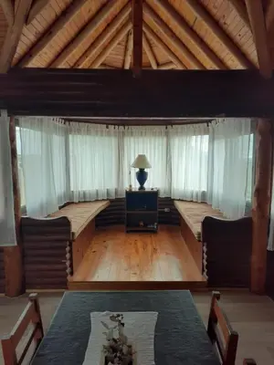 a large room with a table and a lamp at Cabañas El Mirador in Calmayo