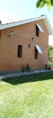 a brick building with windows on the side of it at Marta y Chiche in Mina Clavero