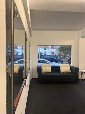 a living room with a couch and a window at LakeHouse Hotel & Suites in Villa Carlos Paz