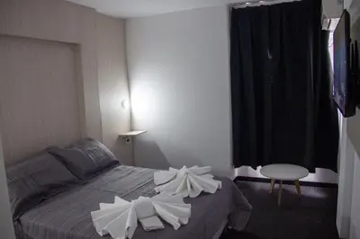 a bedroom with a bed with white flowers on it at LakeHouse Hotel & Suites in Villa Carlos Paz