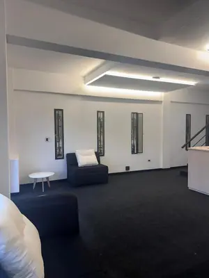 a living room with a couch and a table at LakeHouse Hotel & Suites in Villa Carlos Paz