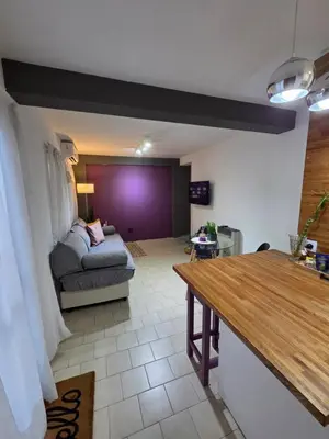 a living room with a bed and a table at Casa Morada in Cordoba