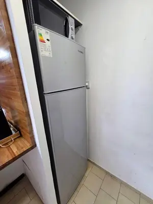 a stainless steel refrigerator in a kitchen next to a counter at Casa Morada in Cordoba