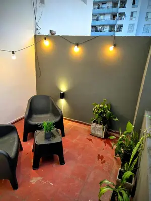 a room with two chairs and a table and lights at Casa Morada in Cordoba