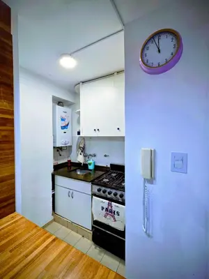 a kitchen with a stove and a clock on the wall at Casa Morada in Cordoba
