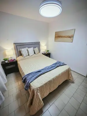 a bedroom with a large bed with a blue blanket at Casa Morada in Cordoba