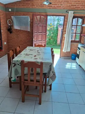 a kitchen with a table and chairs in a room at Marta y Chiche in Mina Clavero
