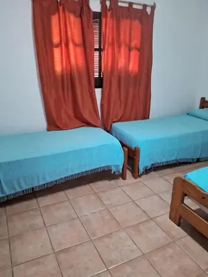 a room with two beds and a window at Marta y Chiche in Mina Clavero