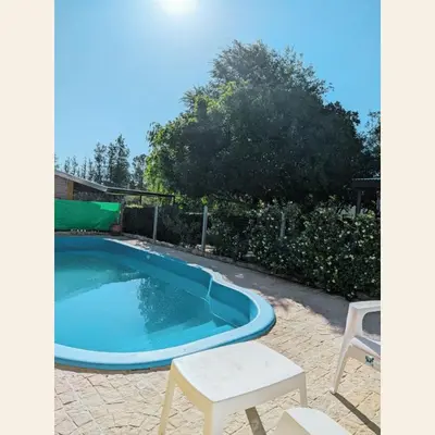 a small pool with a table and chairs next to it at Casa con pileta exclusiva Mina Clavero in Mina Clavero