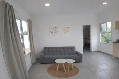 a living room with a couch and two tables at Casa Olivia - Alquiler temporario en Tanti in Tanti