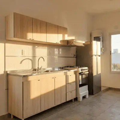 a kitchen with a sink and a stove at Casa Olivia - Alquiler temporario en Tanti in Tanti
