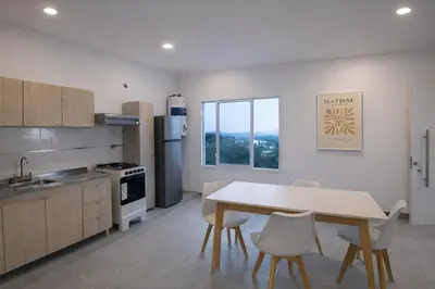 a kitchen with a table and chairs in a room at Casa Olivia - Alquiler temporario en Tanti in Tanti