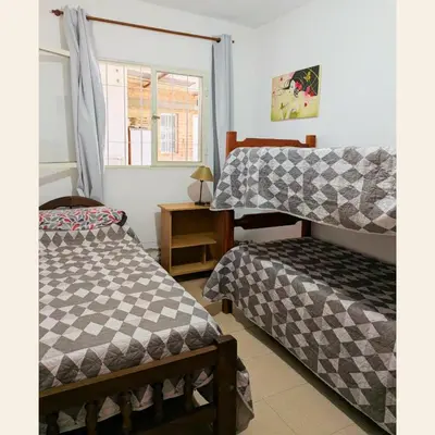 a bedroom with two beds and a window at Lo de Juany in Villa Cura Brochero