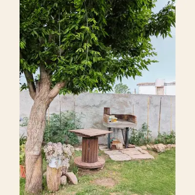 a bench and a table next to a tree at Lo de Juany in Villa Cura Brochero