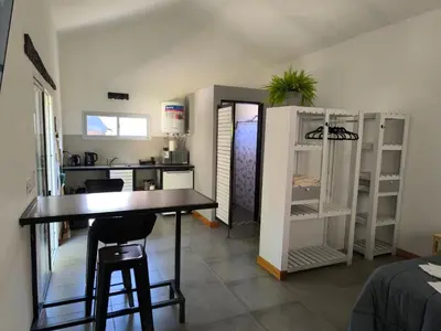 a kitchen with a table and chairs in a room at AlojaMenta in Nono