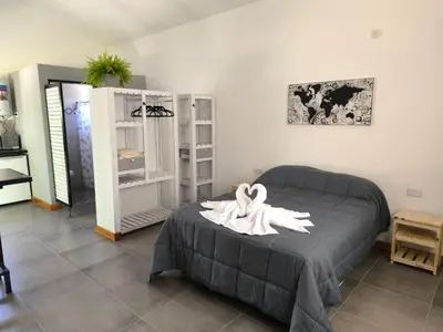 a bedroom with a bed with a white towel on it at AlojaMenta in Nono