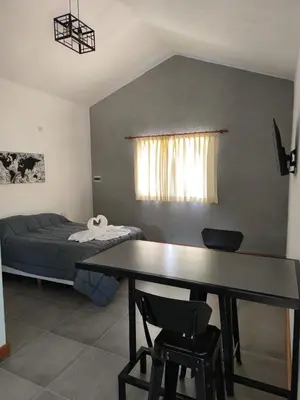 a living room with a table and a bed at AlojaMenta in Nono