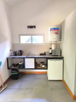 a kitchen with a counter with a sink and a microwave at AlojaMenta in Nono