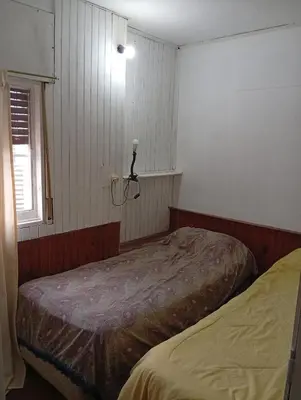 a bedroom with two beds and a window at casa en Tanti in Tanti