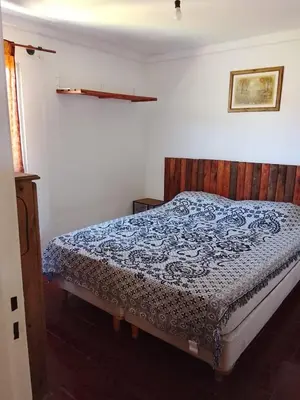 a bedroom with a bed with a blue comforter at Majo in San Francisco del Monte de Oro