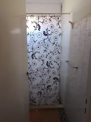 a bathroom with a shower with a black and white pattern at Majo in San Francisco del Monte de Oro
