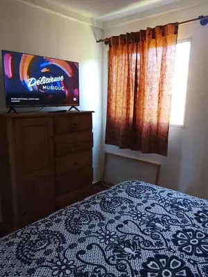 a bedroom with a bed and a television on a dresser at Majo in San Francisco del Monte de Oro