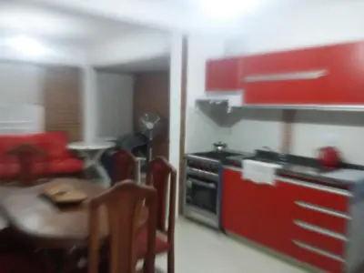 a kitchen with red cabinets and a table and a stove at Gabriel in Mina Clavero