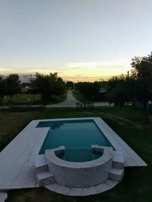 a large swimming pool with a stone wall around it at Gabriel in Mina Clavero