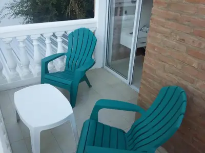 two chairs and a table on a balcony at Gabriel in Mina Clavero
