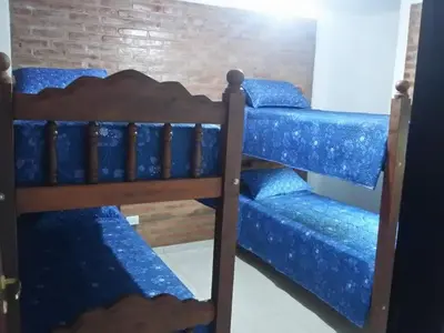 a bunk bed in a room with blue sheets at Gabriel in Mina Clavero
