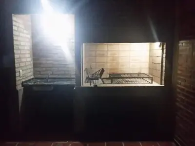 a brick fireplace with a bench in a room at Gabriel in Mina Clavero