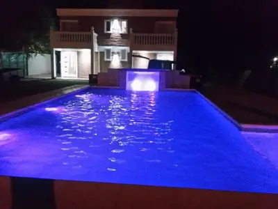 a swimming pool lit up at night at Gabriel in Mina Clavero
