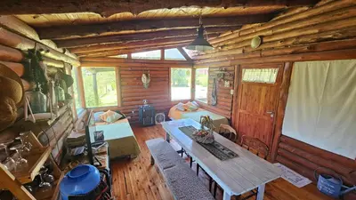 a living room of a log cabin with a table at Cabaña UMI - Un Mundo Infinito in Potrero de Garay