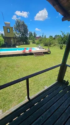a view of a swimming pool from a bench at Cabaña UMI - Un Mundo Infinito in Potrero de Garay