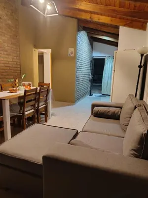 a living room with a couch and a table at Cabaña Quimey in Villa Rumipal