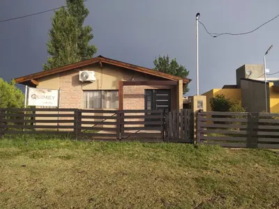 a small house with a fence in front of it at Cabaña Quimey in Villa Rumipal