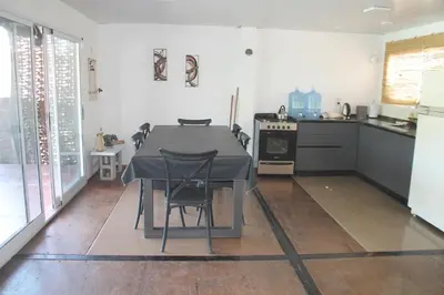 a kitchen with a table and chairs in a room at Mirabela Casa con vista panorámica a las sierras en Bialet Massé- Hasta 4 personas in Bialet Massé