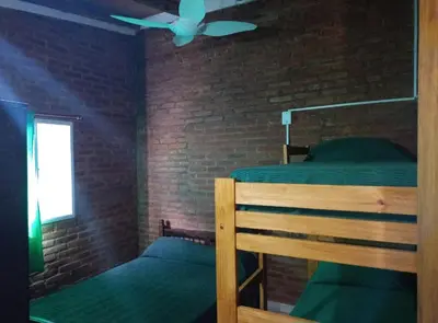 a bedroom with a bunk bed and a ceiling fan at Mi Niña's in Villa Cura Brochero