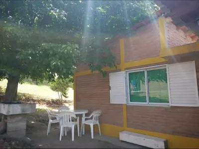 a table and chairs in front of a building at Mi Niña's in Villa Cura Brochero