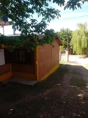 a small building with a tree in front of it at Mi Niña's in Villa Cura Brochero
