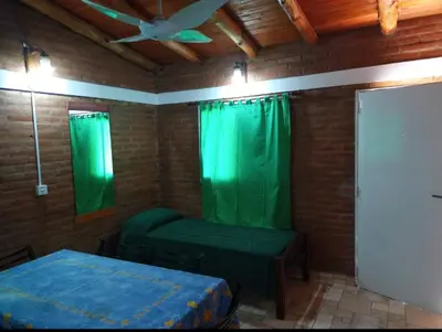 a room with green curtains and a bed and a ceiling at Mi Niña's in Villa Cura Brochero