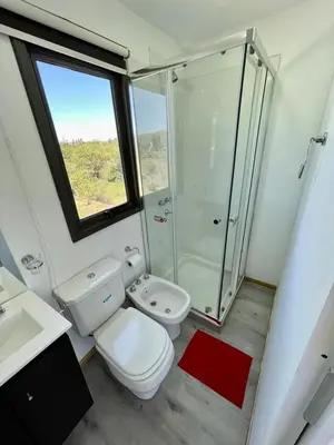 a bathroom with a toilet and a shower and a sink at Containers UMI - Un Mundo Infinito in Potrero de Garay