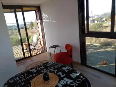 a bedroom with a bed and a view of a yard at Containers UMI - Un Mundo Infinito in Potrero de Garay