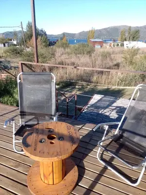 a table and chairs on top of a deck at Containers UMI - Un Mundo Infinito in Potrero de Garay