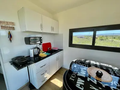 a small kitchen with a table in a room at Containers UMI - Un Mundo Infinito in Potrero de Garay