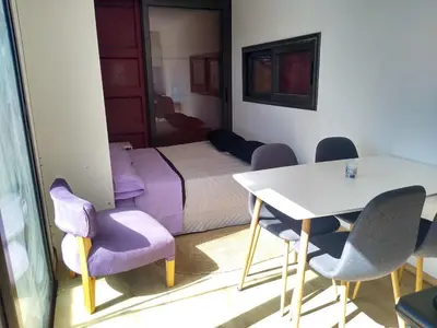 a room with a bed and a table and chairs at Containers UMI - Un Mundo Infinito in Potrero de Garay